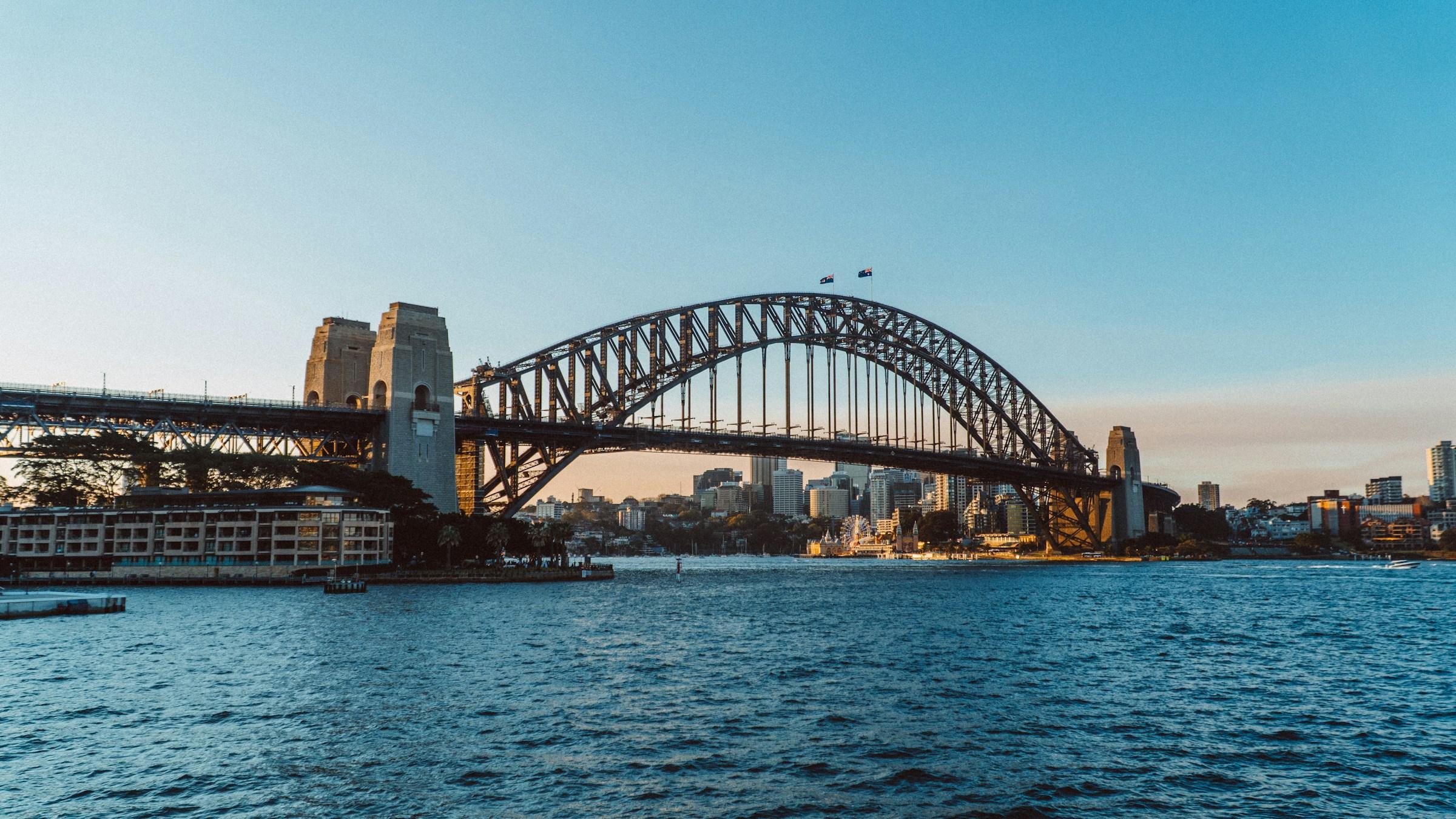 The Sydney Harbour Bridge across the harbour in the late afternoon