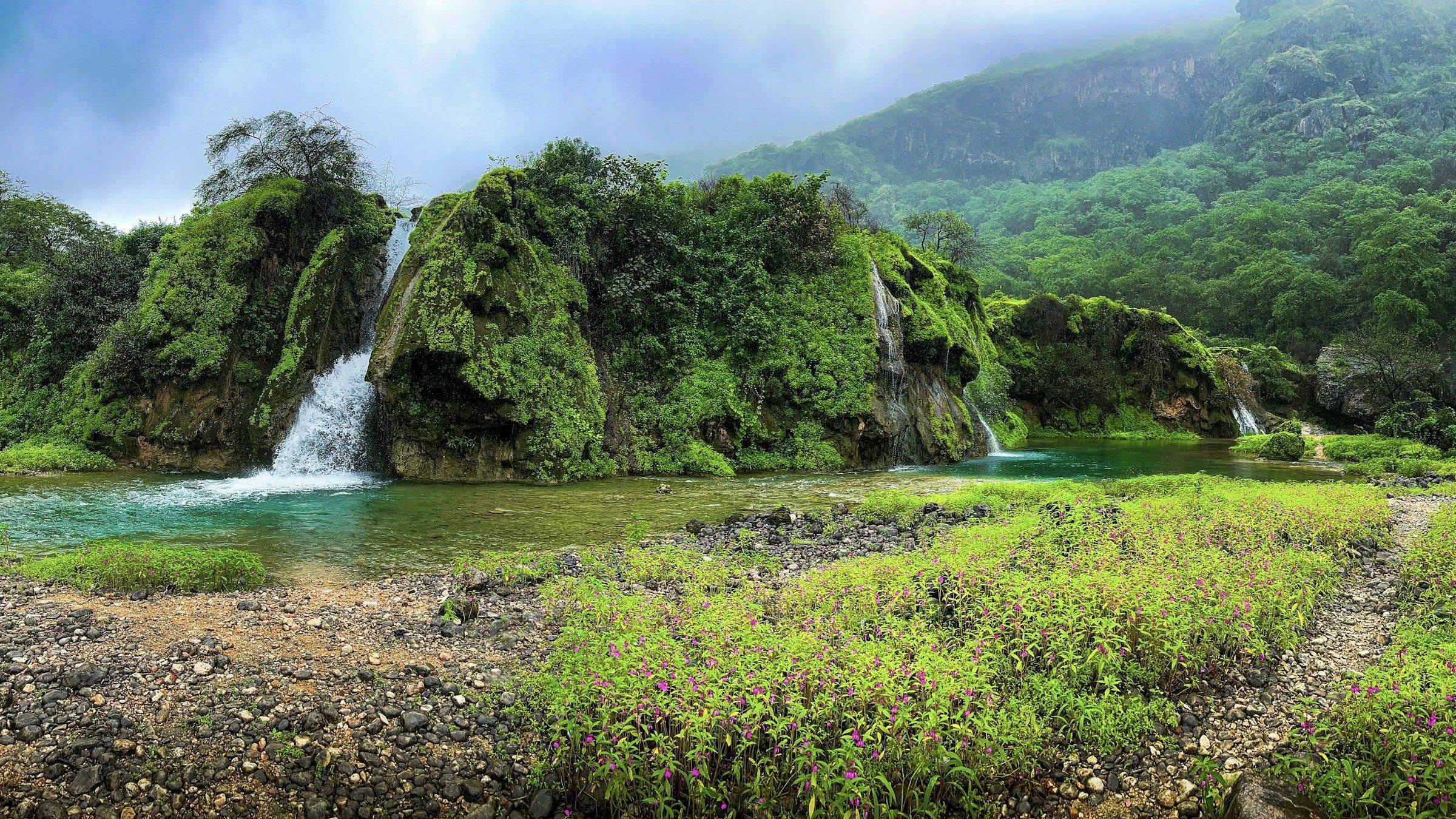 Waterfalls and green hills near Salalah in the khareef season, Dhofar, Oman
