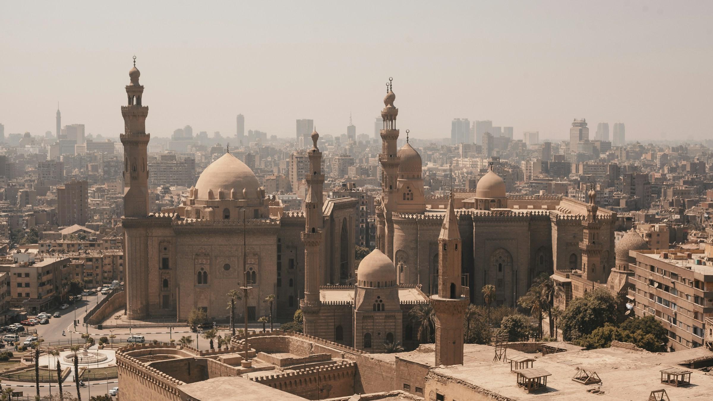 The Sultan Hassan and Al-Rifai mosques above the rooftops of Cairo