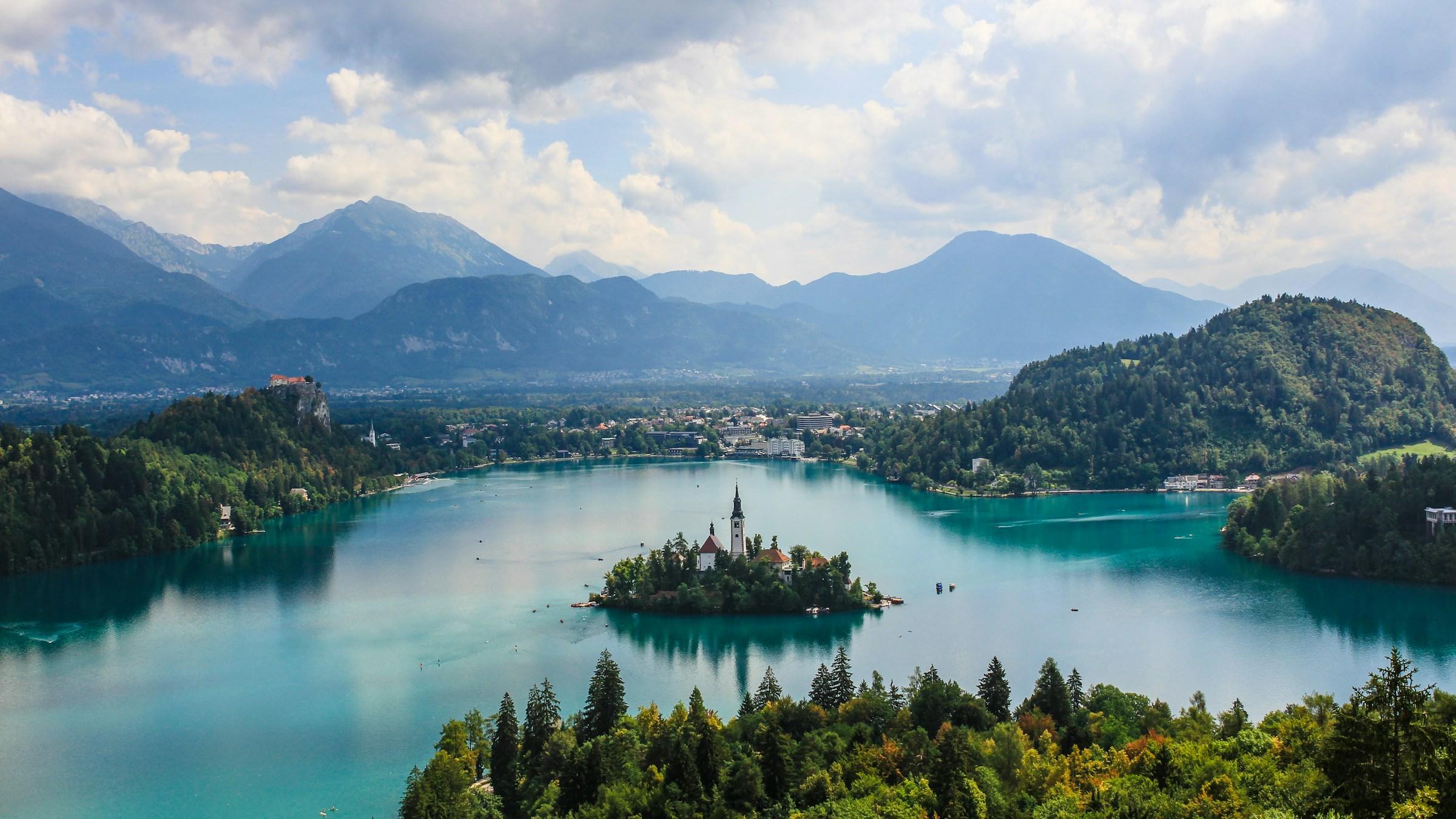 Lake Bled and its island church, with Bled Castle on its cliff and the Julian Alps behind