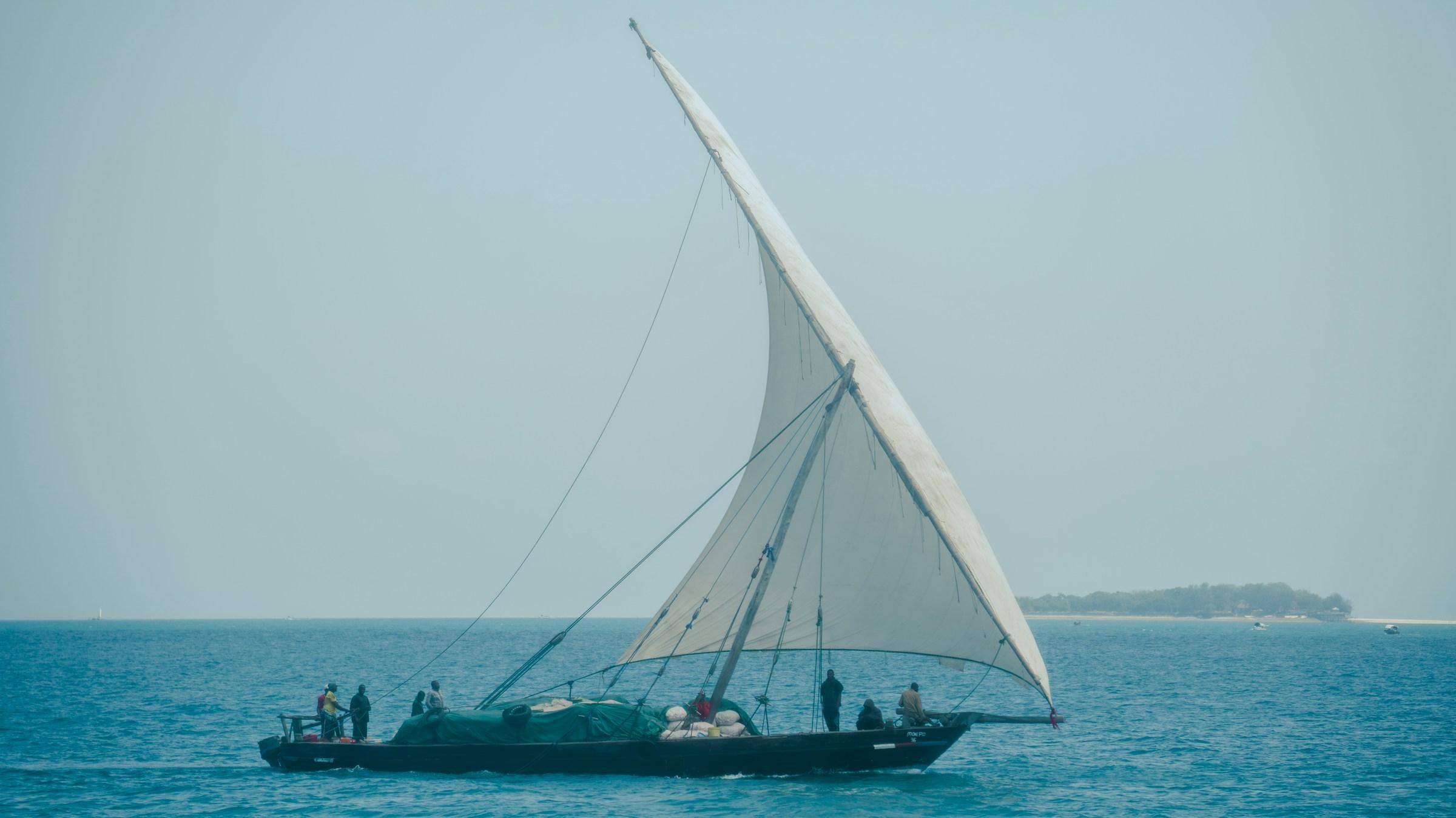 A dhow under sail on the turquoise sea off Zanzibar