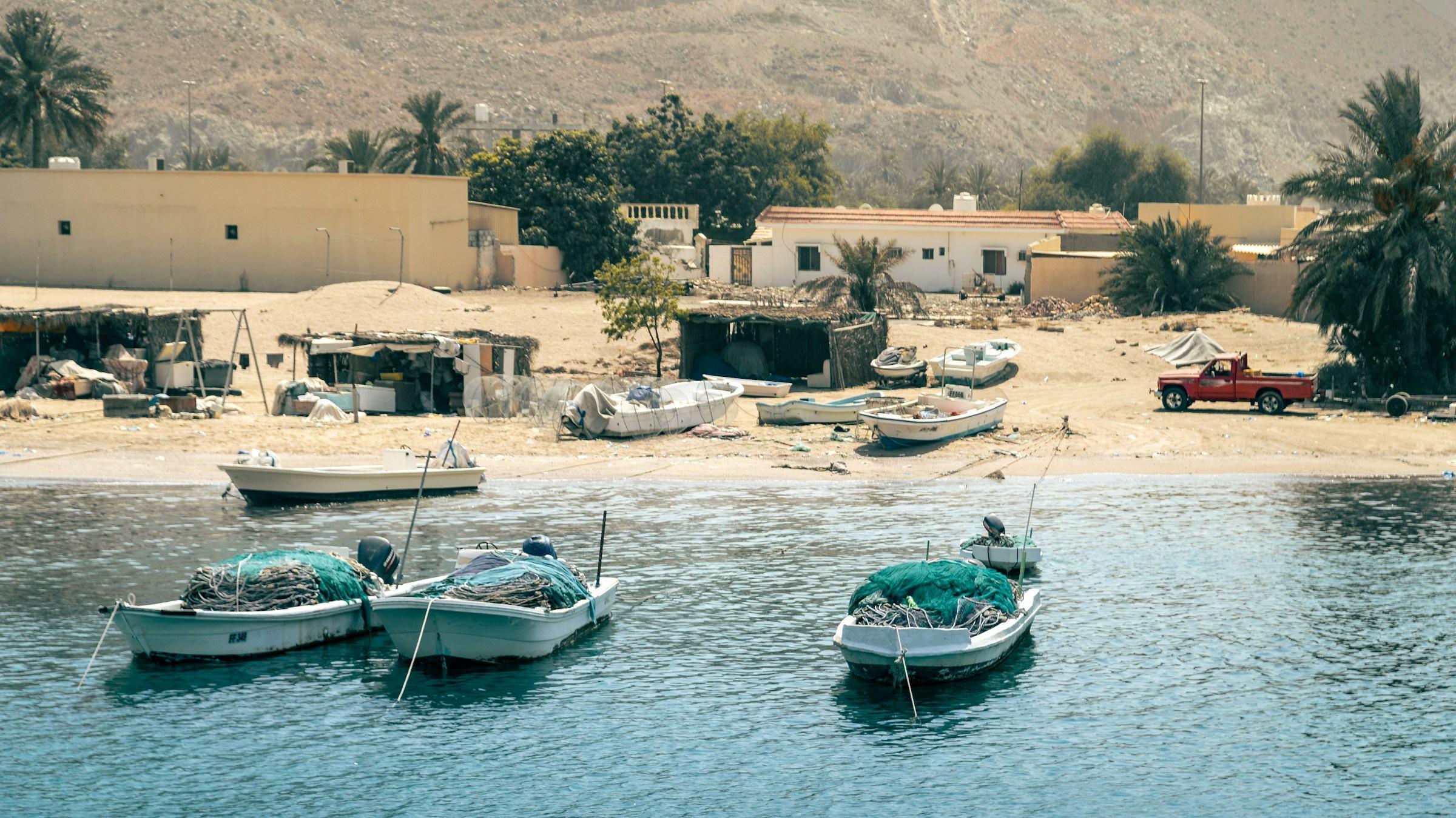 Fishing boats moored off a village beach in Fujairah