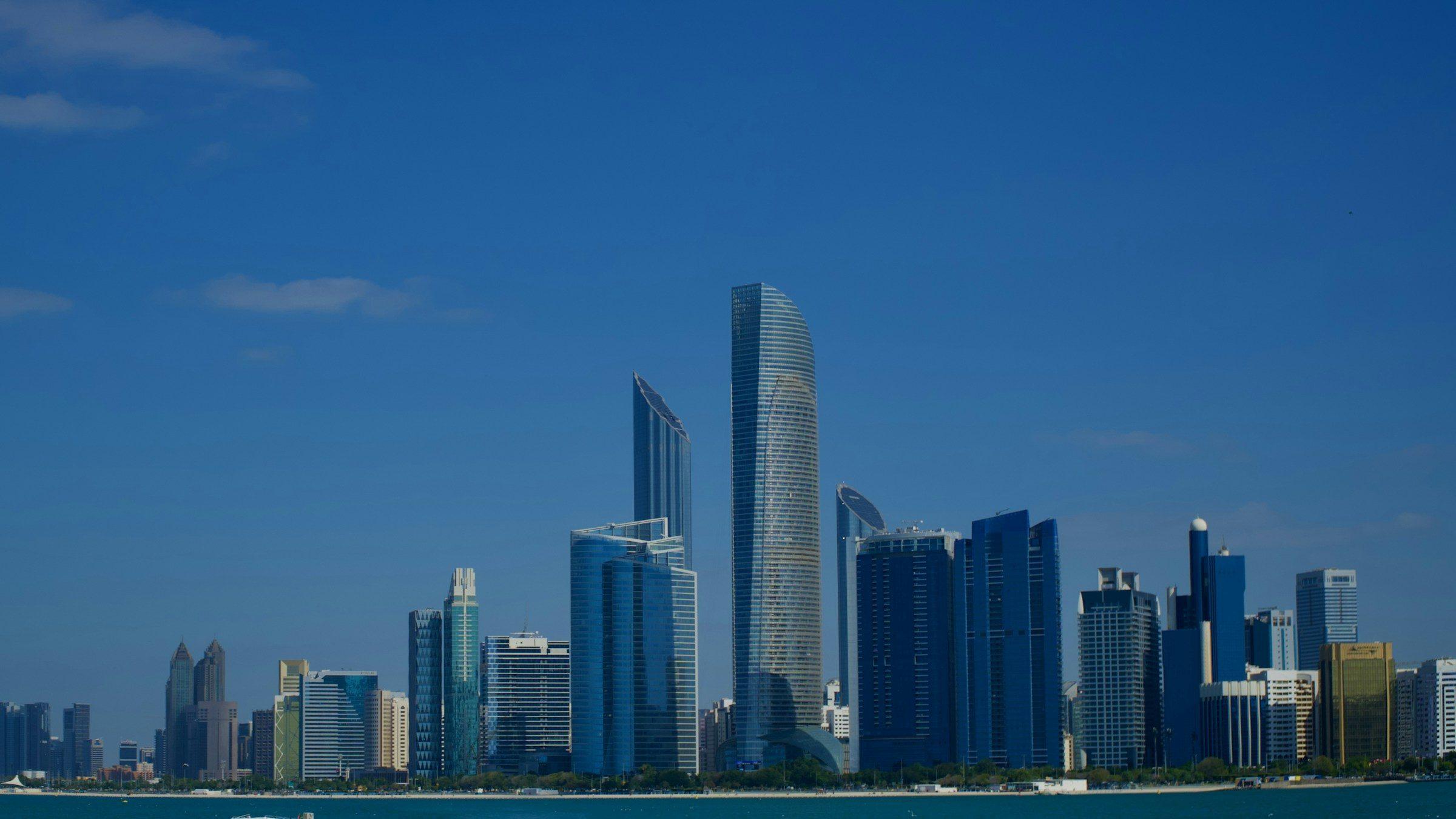 Abu Dhabi's skyline across the water on a clear day