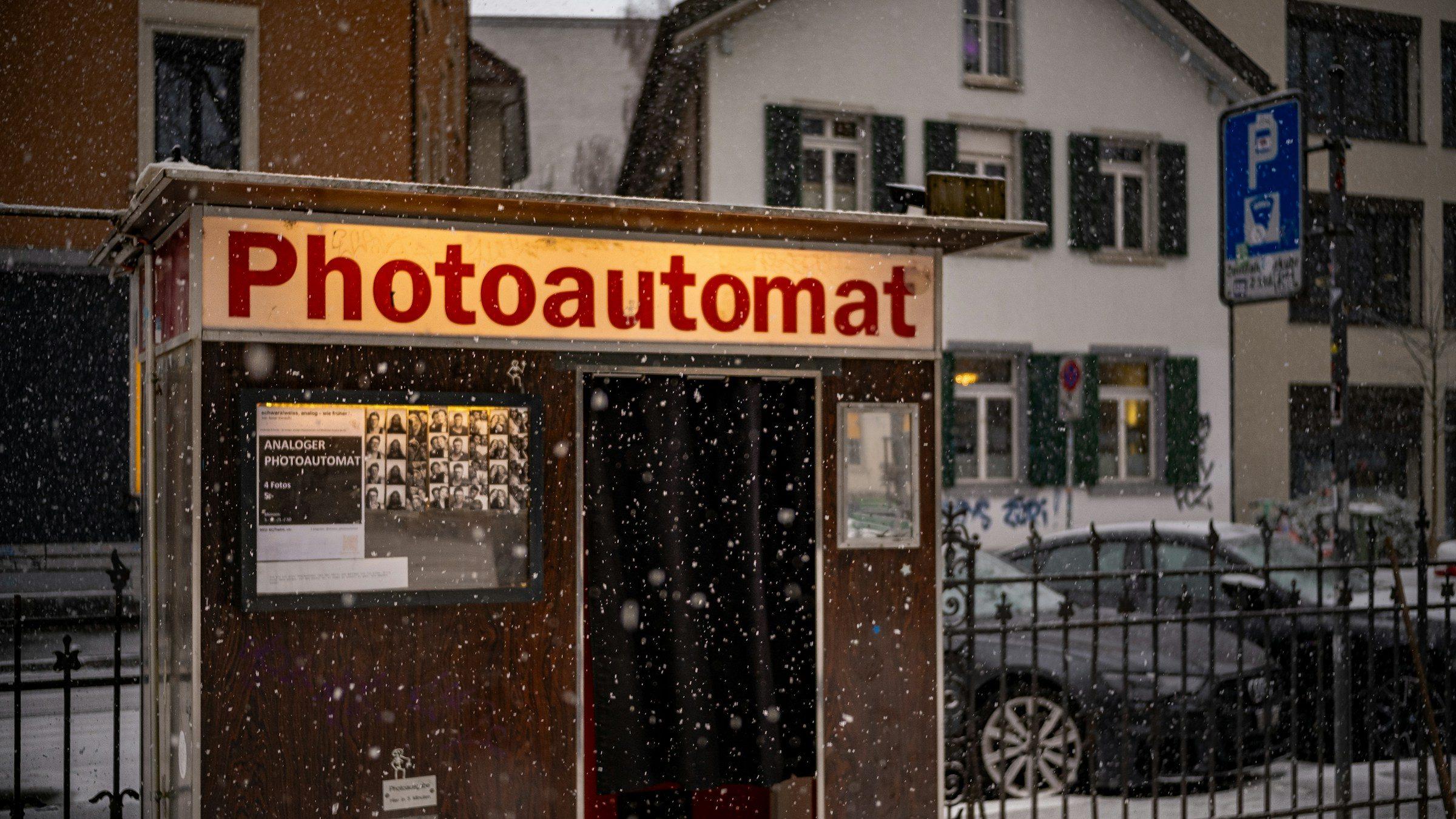 An old photo booth on a snowy street