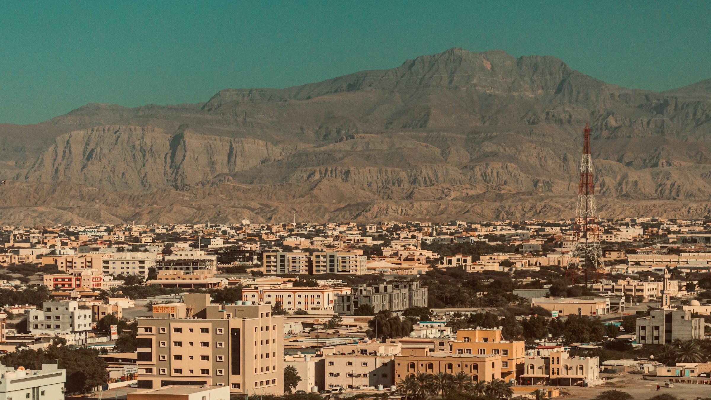 Ras Al Khaimah city spread below the Hajar Mountains