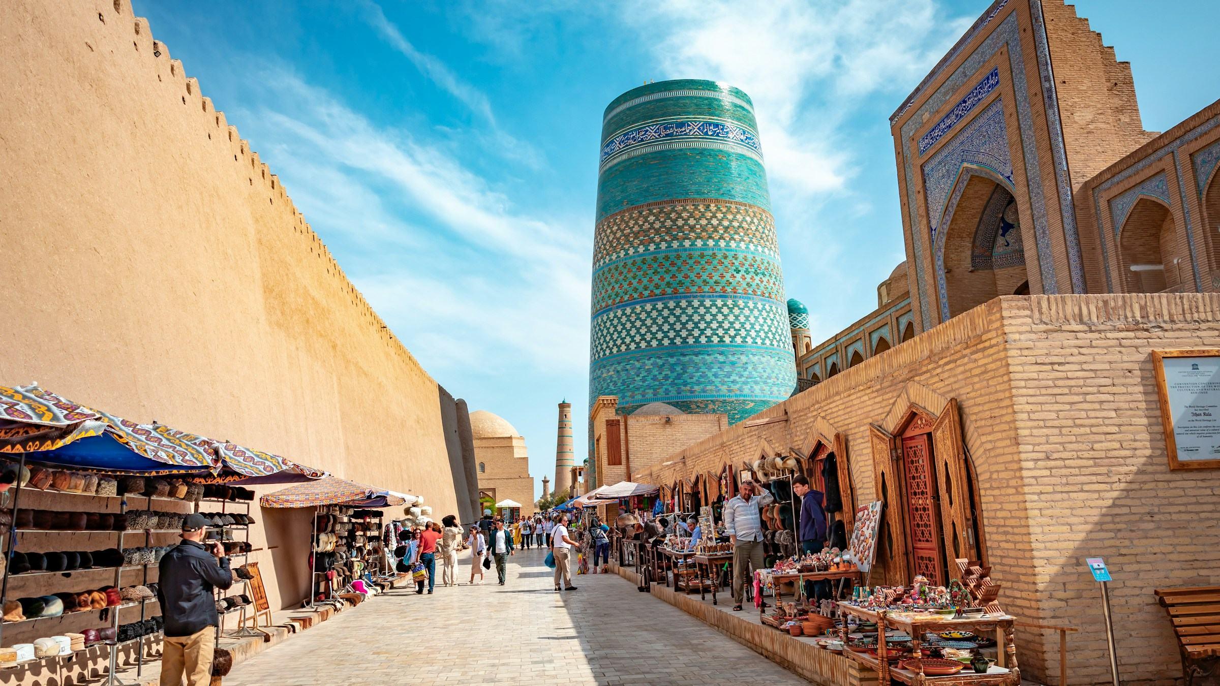 The tiled Kalta Minor minaret beside the walls of Itchan Kala in Khiva, Uzbekistan