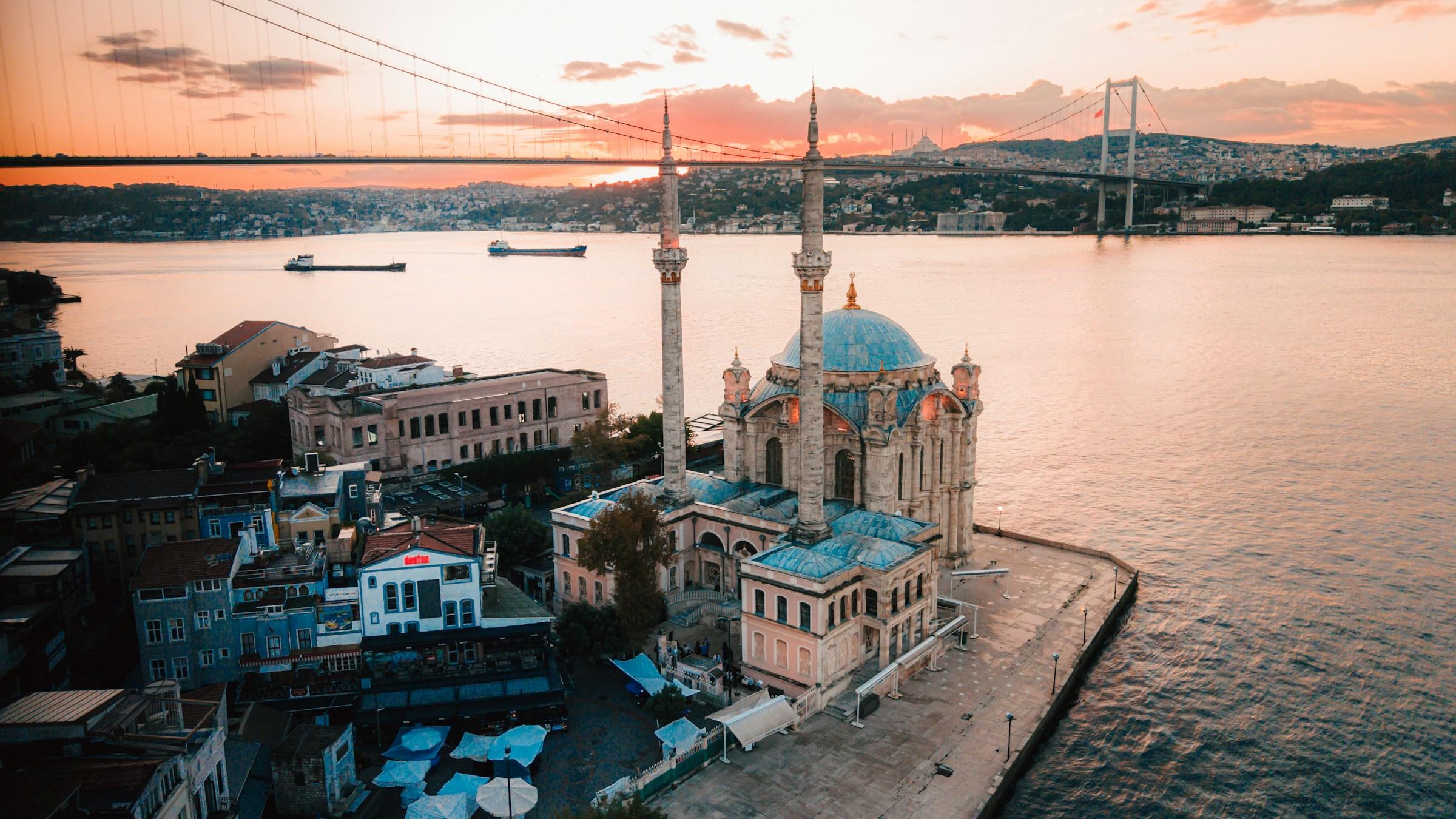 The Ortaköy Mosque on the Bosphorus at sunset, with the Bosphorus Bridge behind, Istanbul