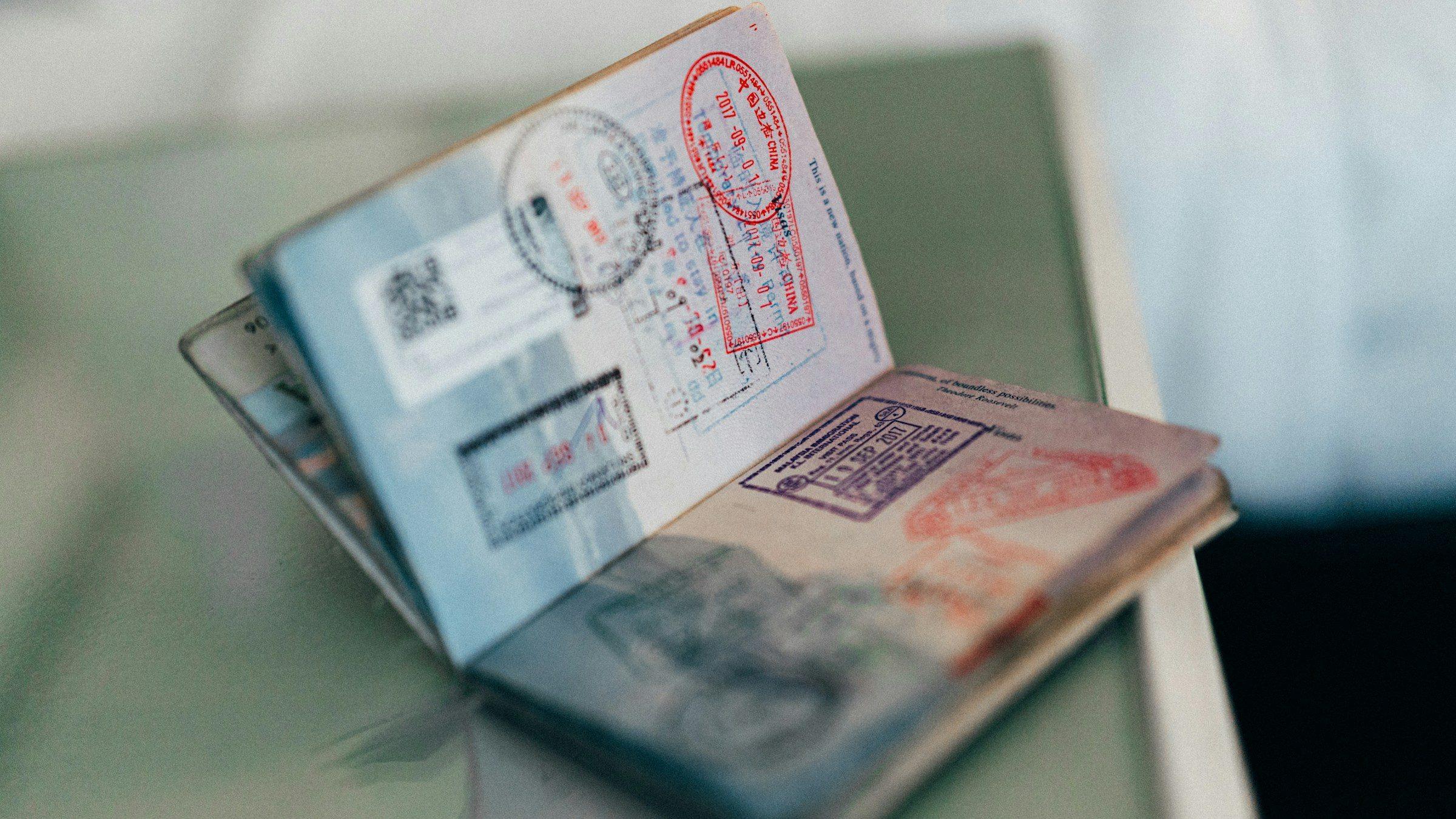 An open passport filled with entry and exit stamps