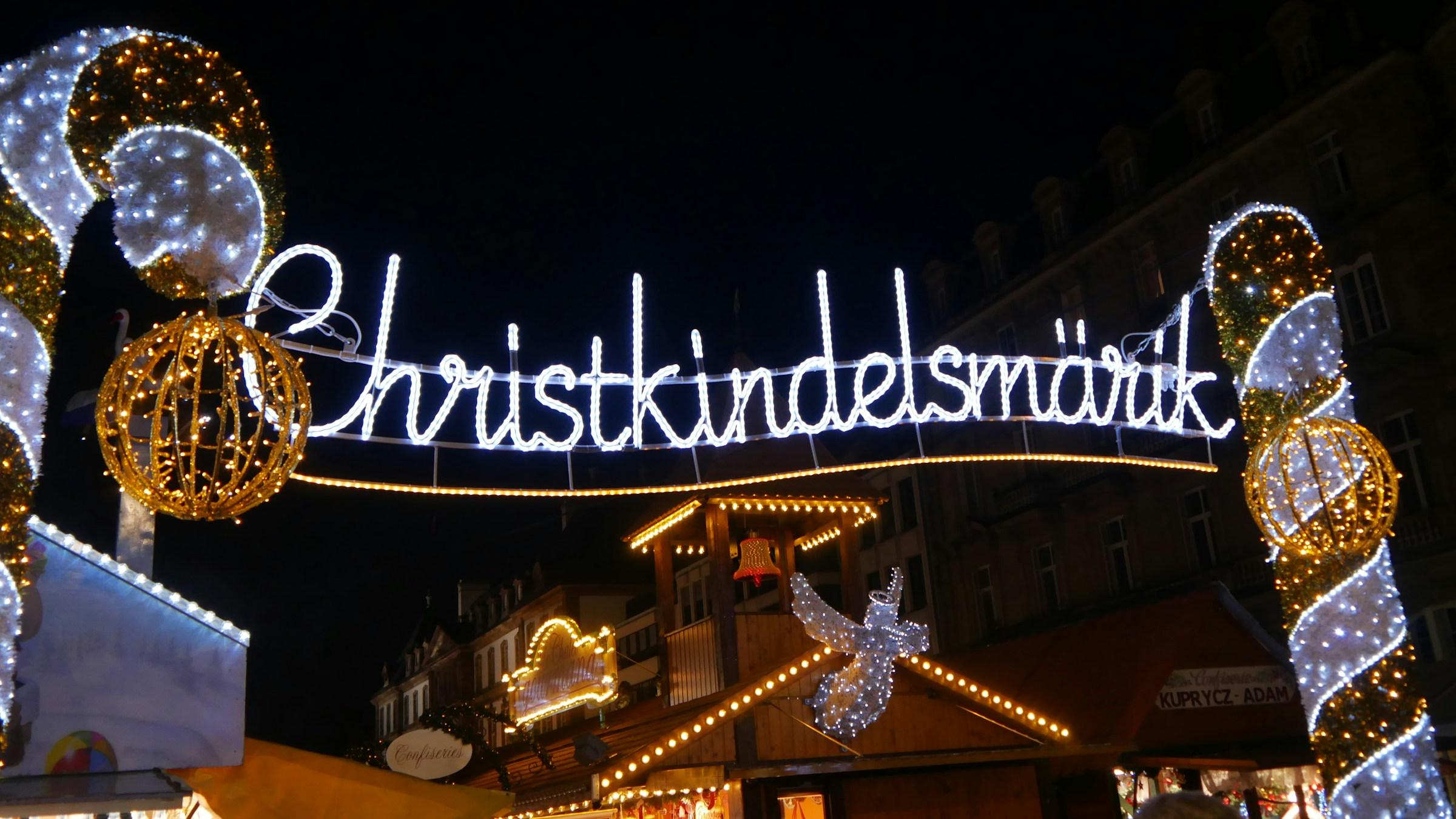 The lit Christkindelsmärik sign at Strasbourg's Christmas market