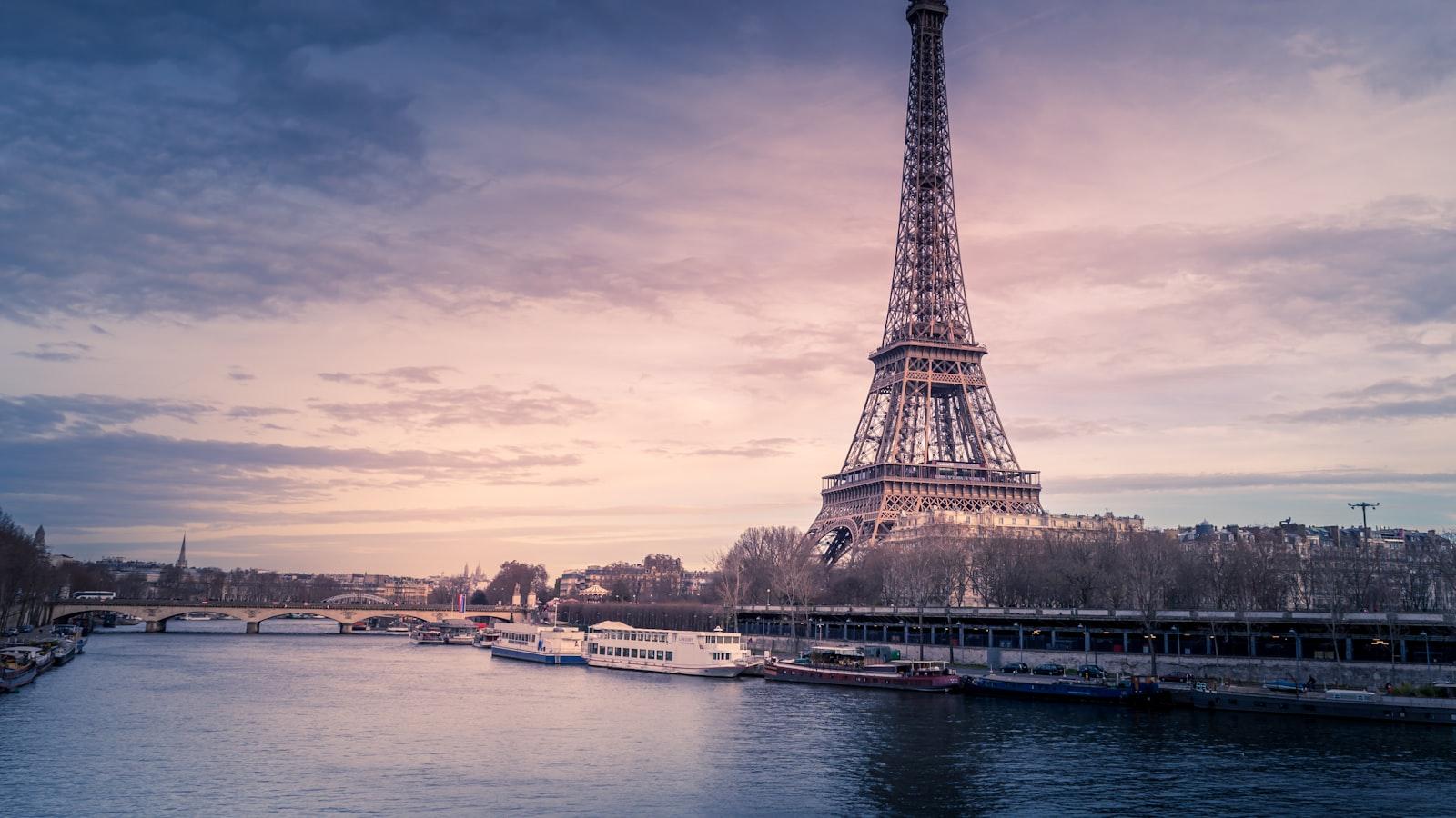 The Eiffel Tower above the Seine in Paris at dusk