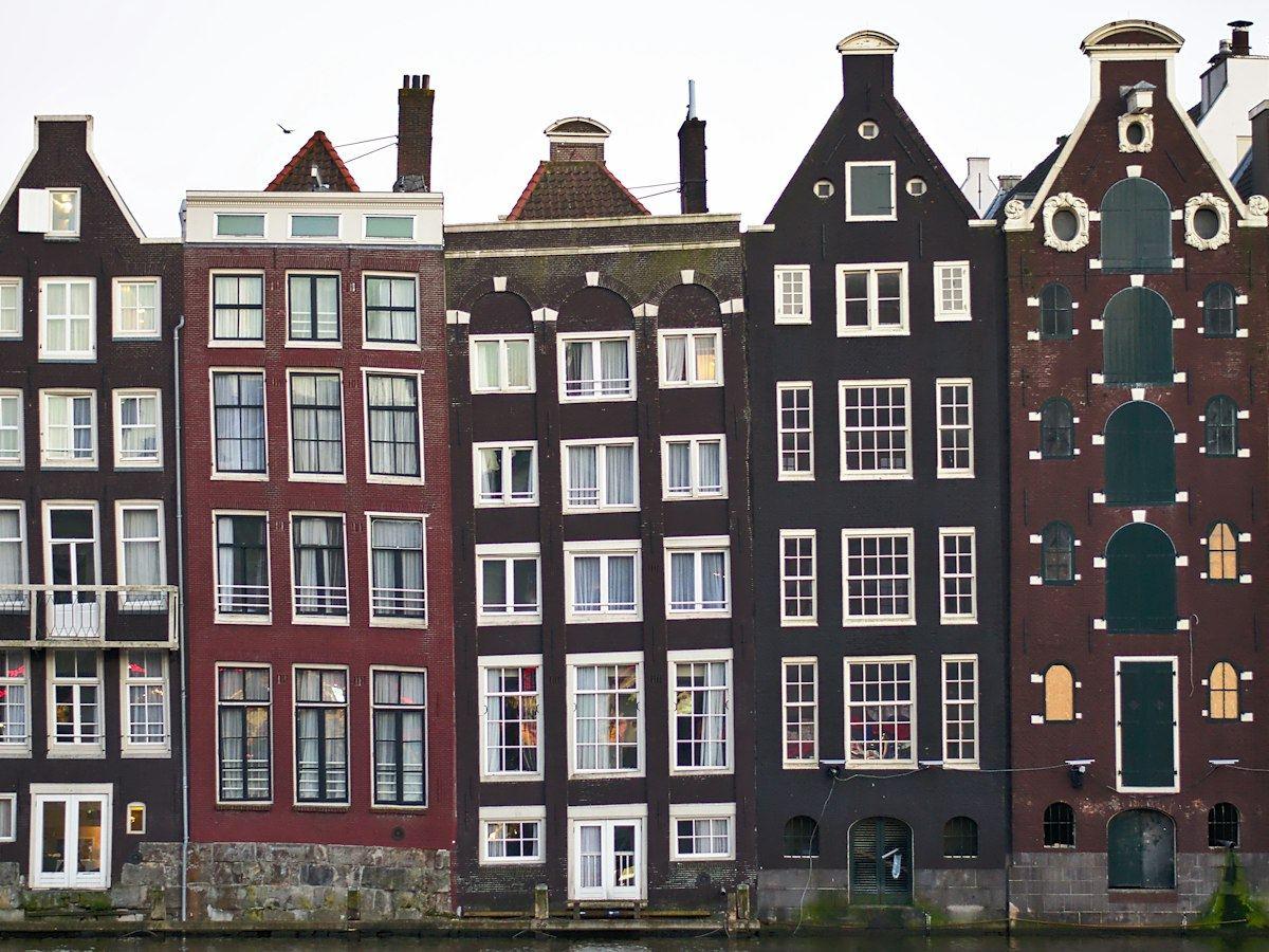 Leaning canal houses along the Damrak in Amsterdam