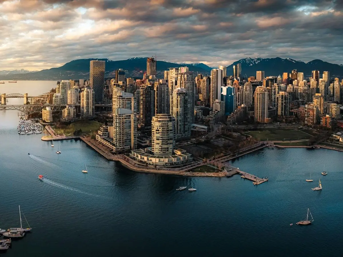 Downtown Vancouver and False Creek from above, with the mountains behind