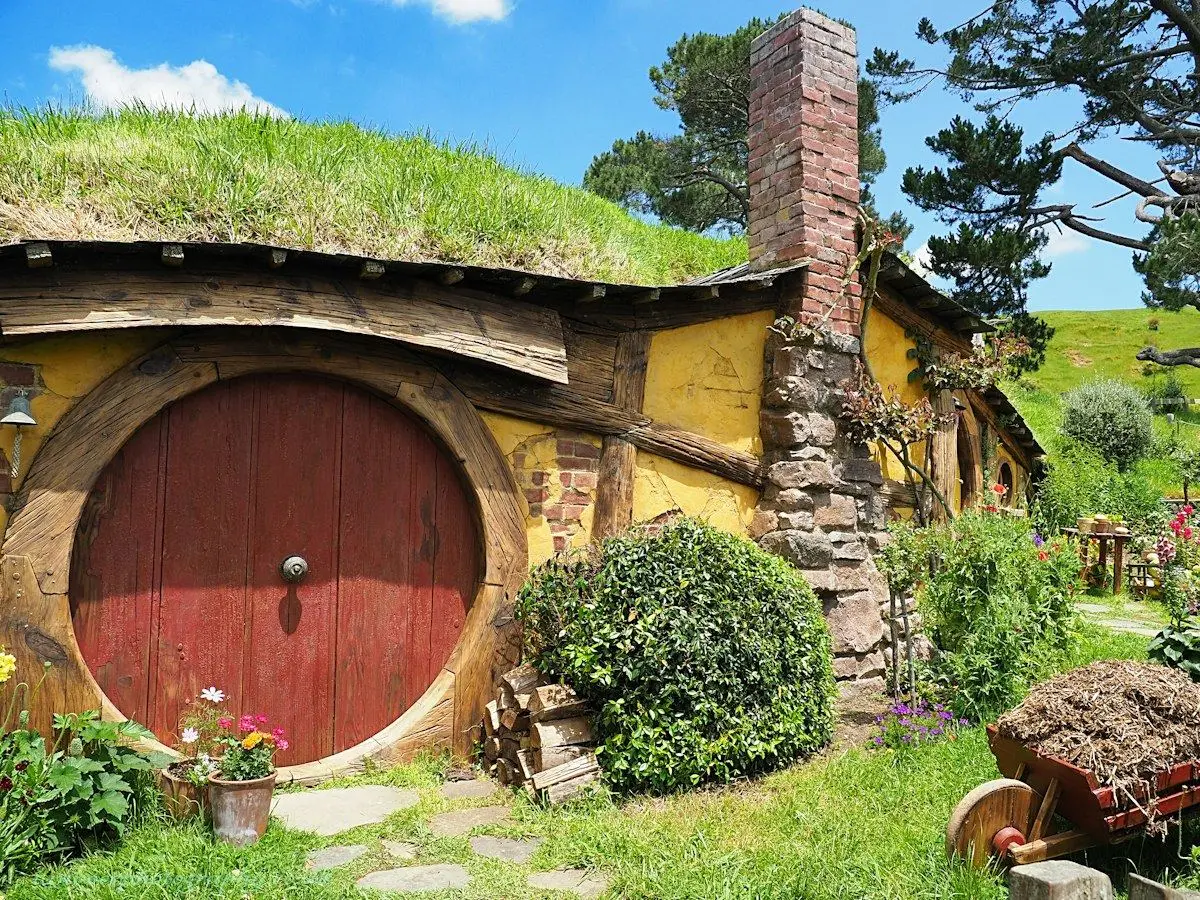 The round green door of a hobbit hole at the Hobbiton Movie Set