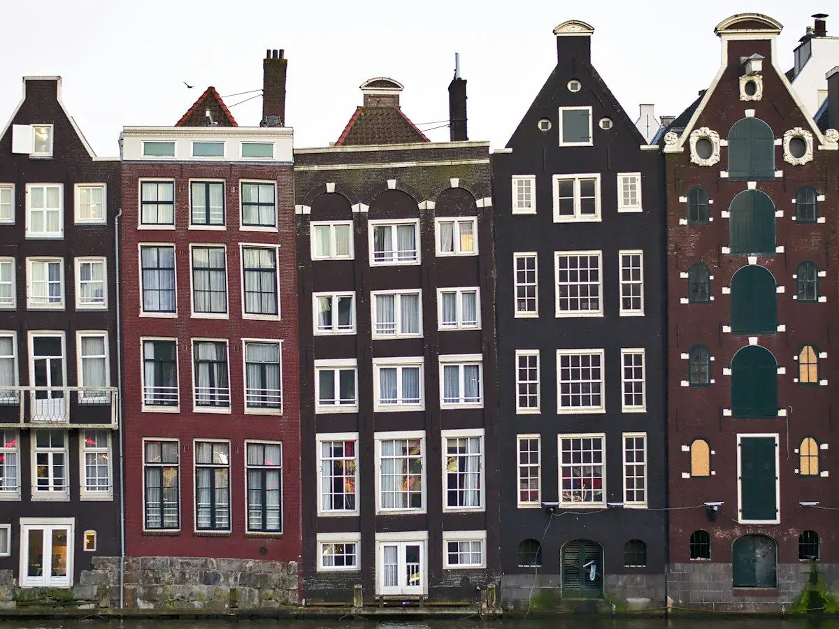 Leaning canal houses along the Damrak in Amsterdam