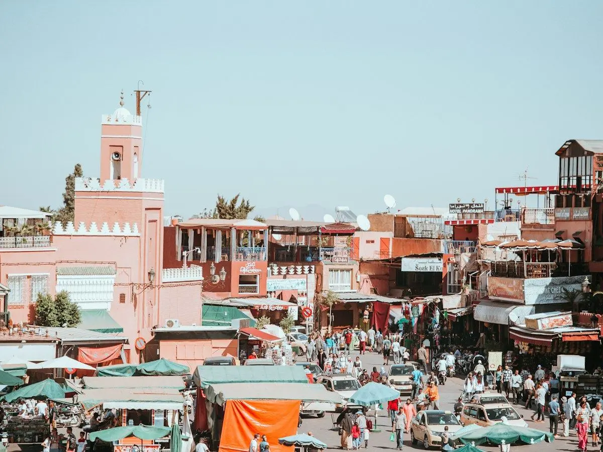 Market stalls and a minaret in the medina of Marrakesh