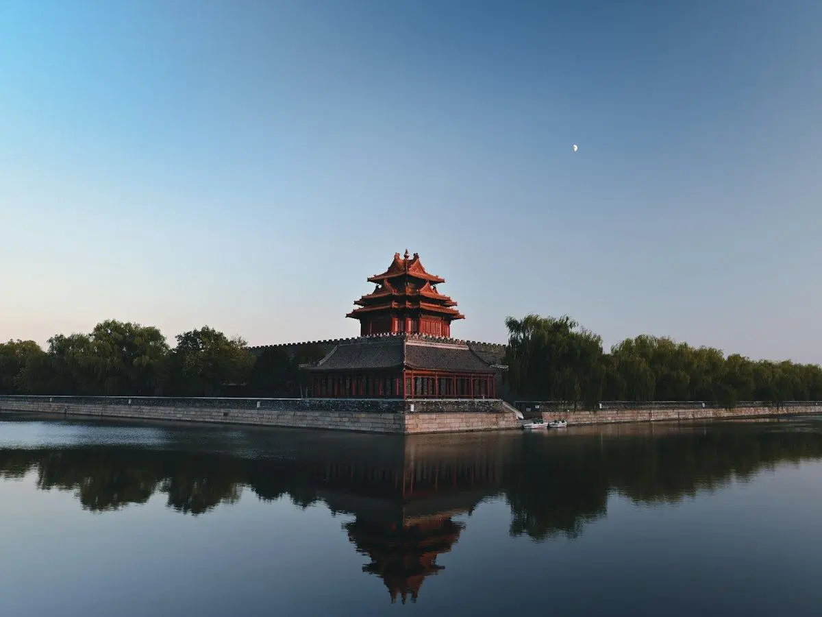 A corner tower of the Forbidden City reflected in its moat in Beijing