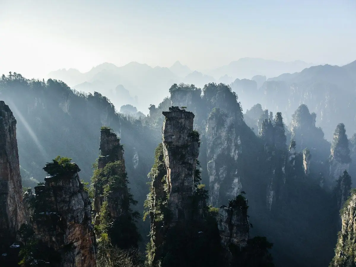 Sandstone pillars rising from a misty valley in Zhangjiajie
