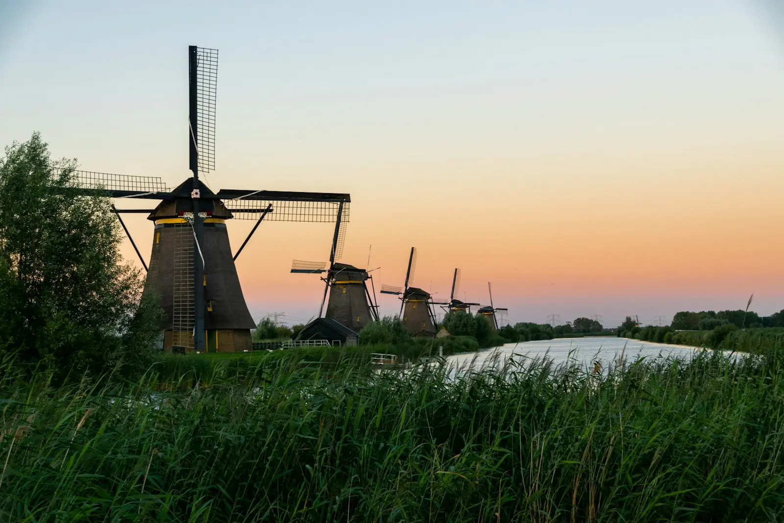 Windmills along a canal at Kinderdijk at sunset