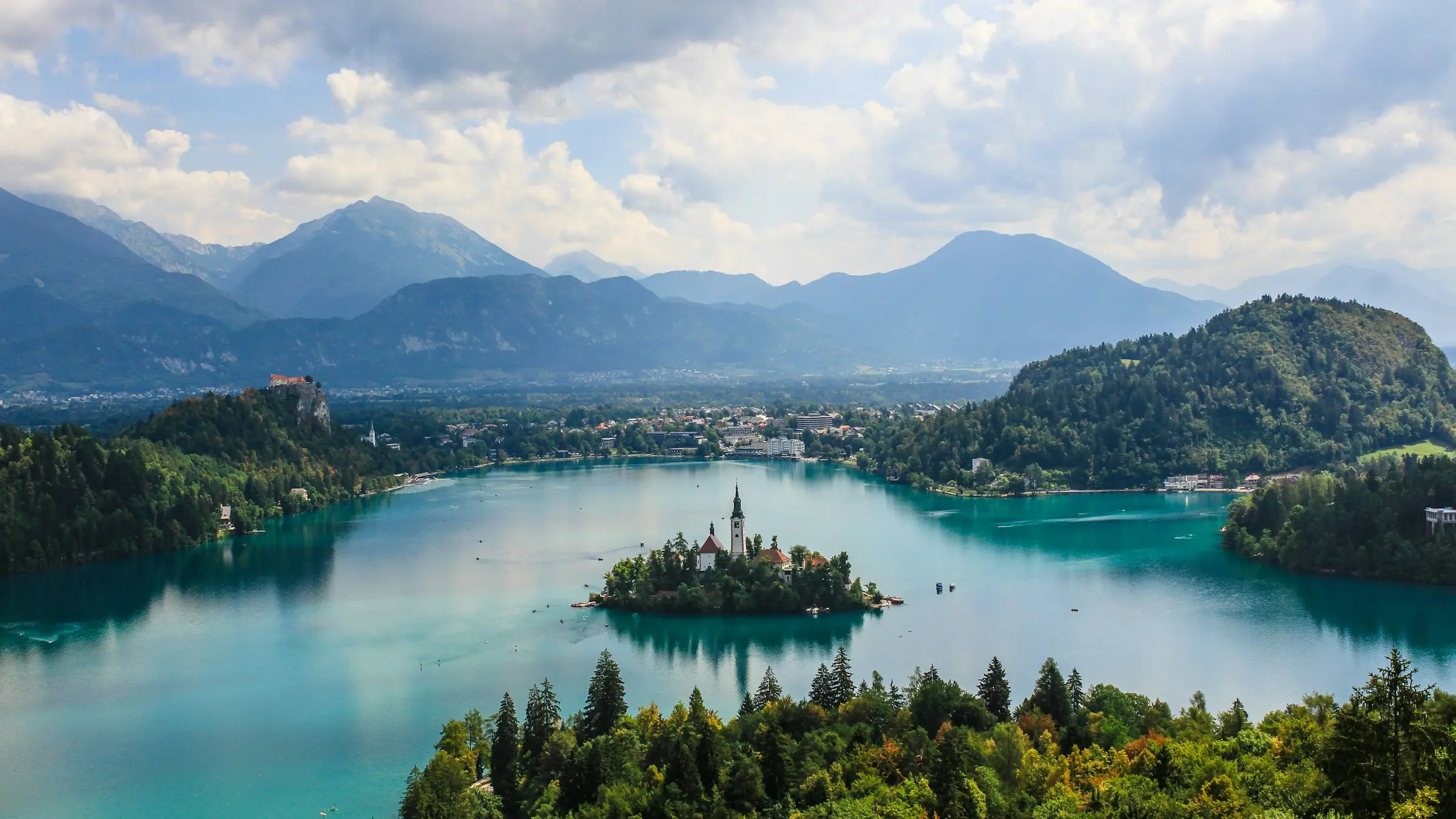 Lake Bled and its island church, with Bled Castle on its cliff and the Julian Alps behind