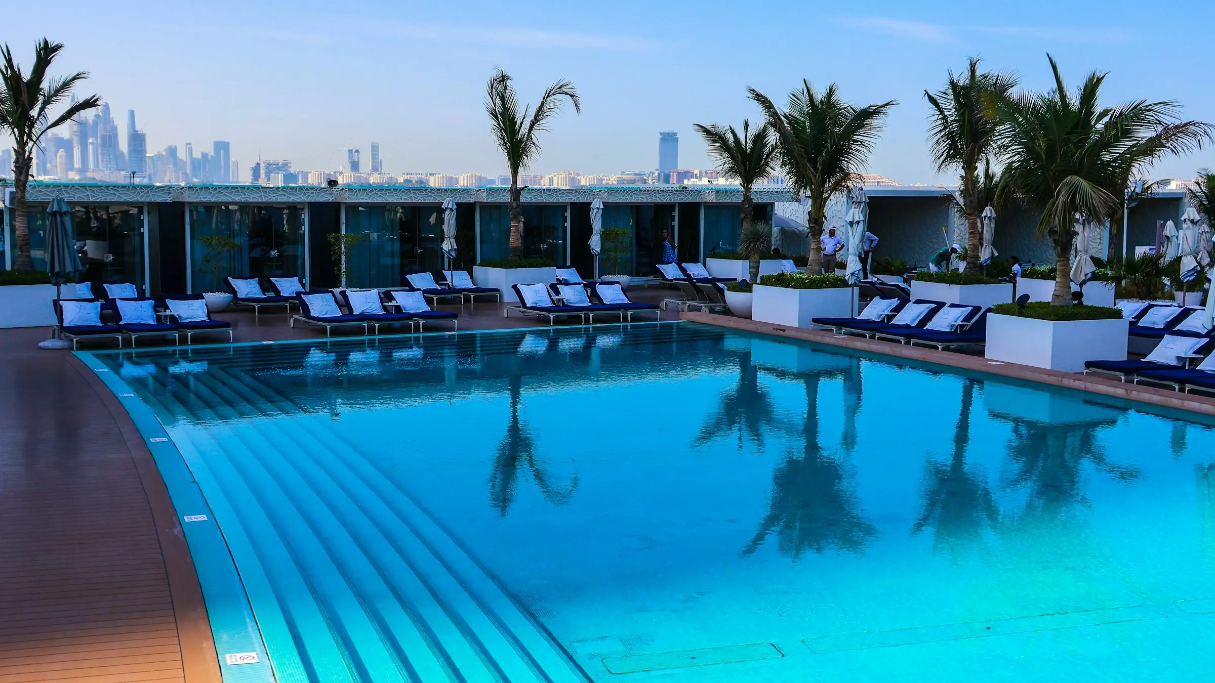 The pool terrace at the Burj Al Arab in the morning, with Dubai Marina beyond