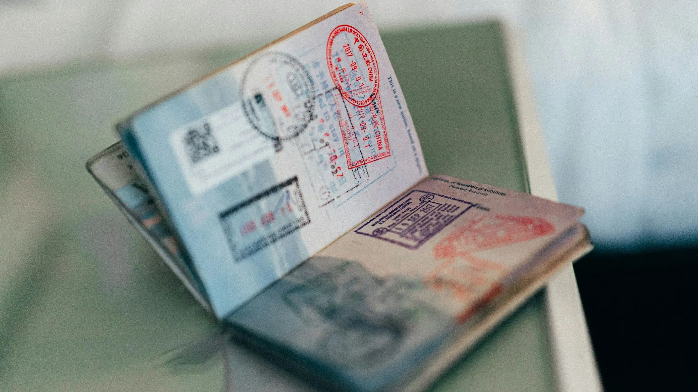 An open passport filled with entry and exit stamps