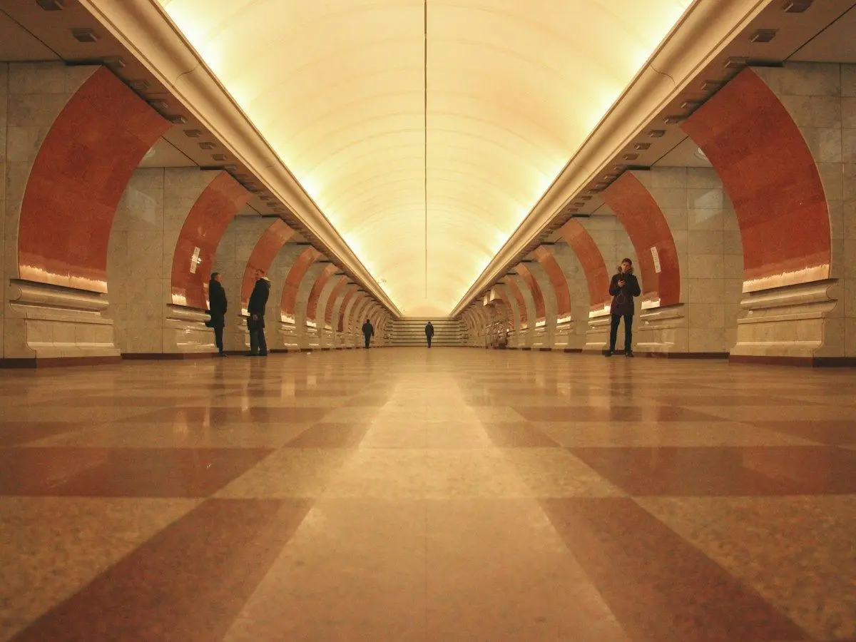 A long, lit platform hall in a Moscow Metro station