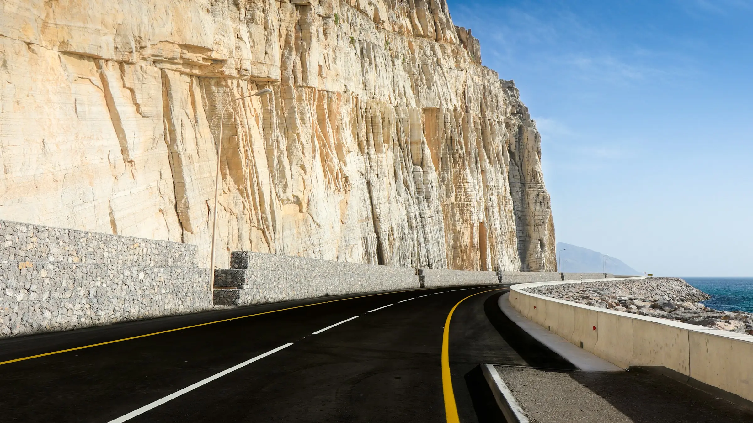 The Khasab coastal road below the cliffs of Musandam, Oman
