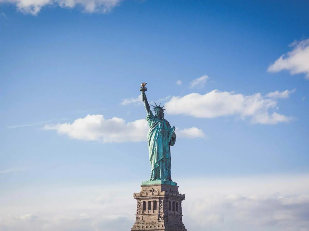 The Statue of Liberty against a blue sky in New York Harbor