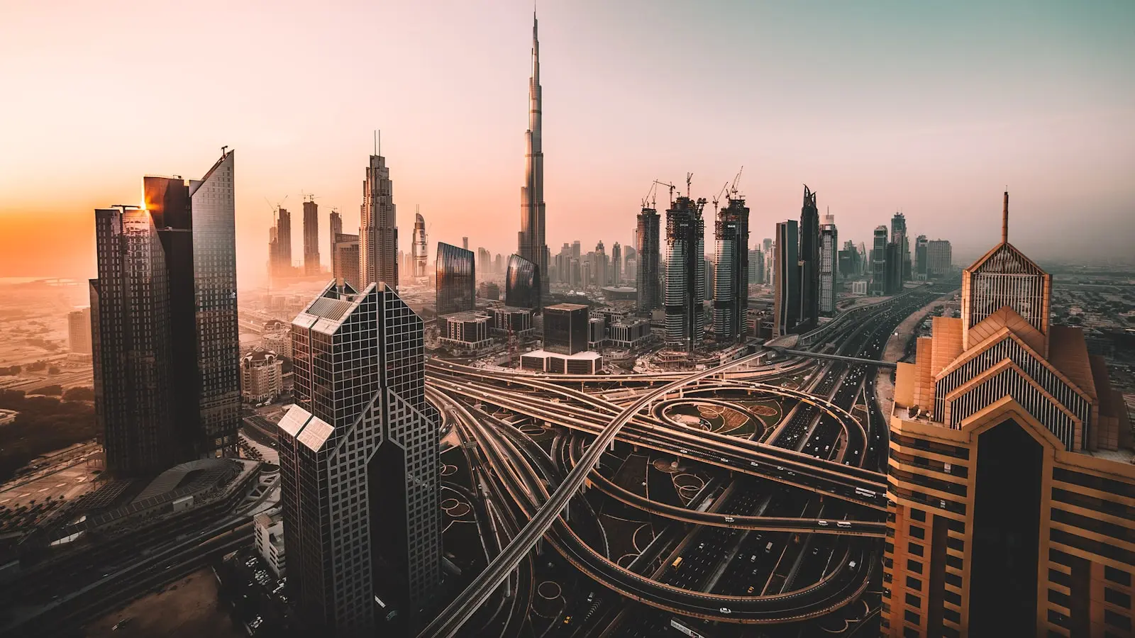 Downtown Dubai and the Burj Khalifa above the Sheikh Zayed Road interchange at dusk