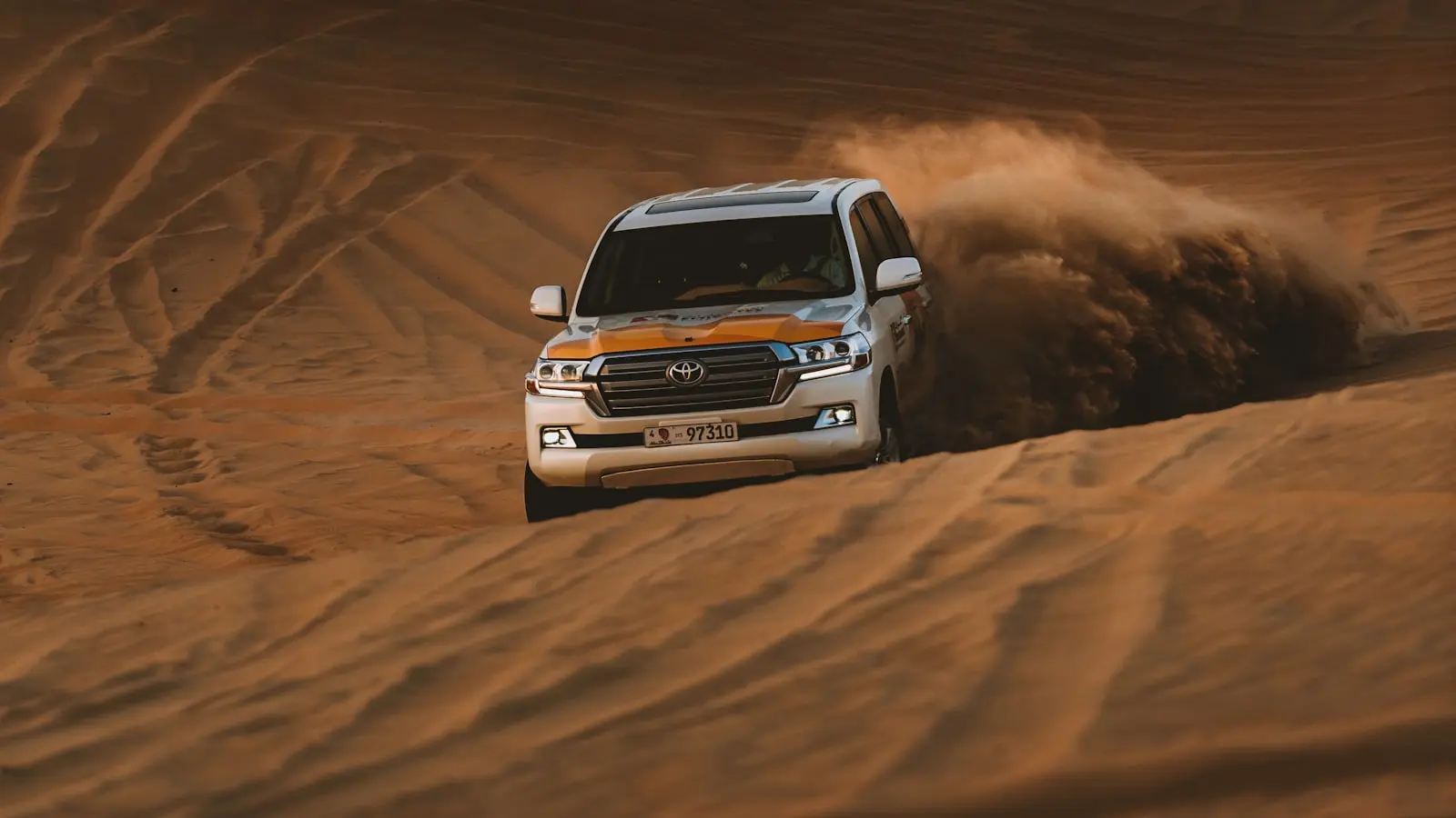 Four-wheel drive on the dunes outside Dubai at sunset