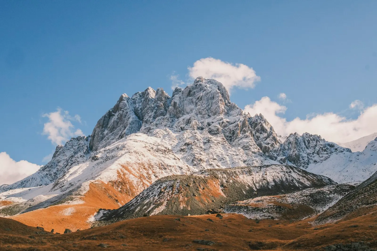 The snow-dusted Chaukhi massif above the Juta valley in autumn
