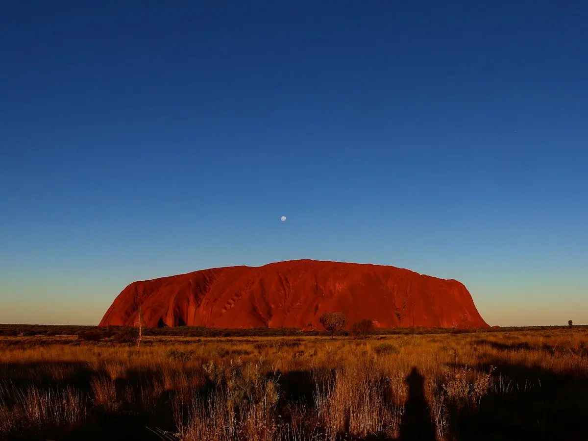 Uluru glowing red at dusk in the Northern Territory