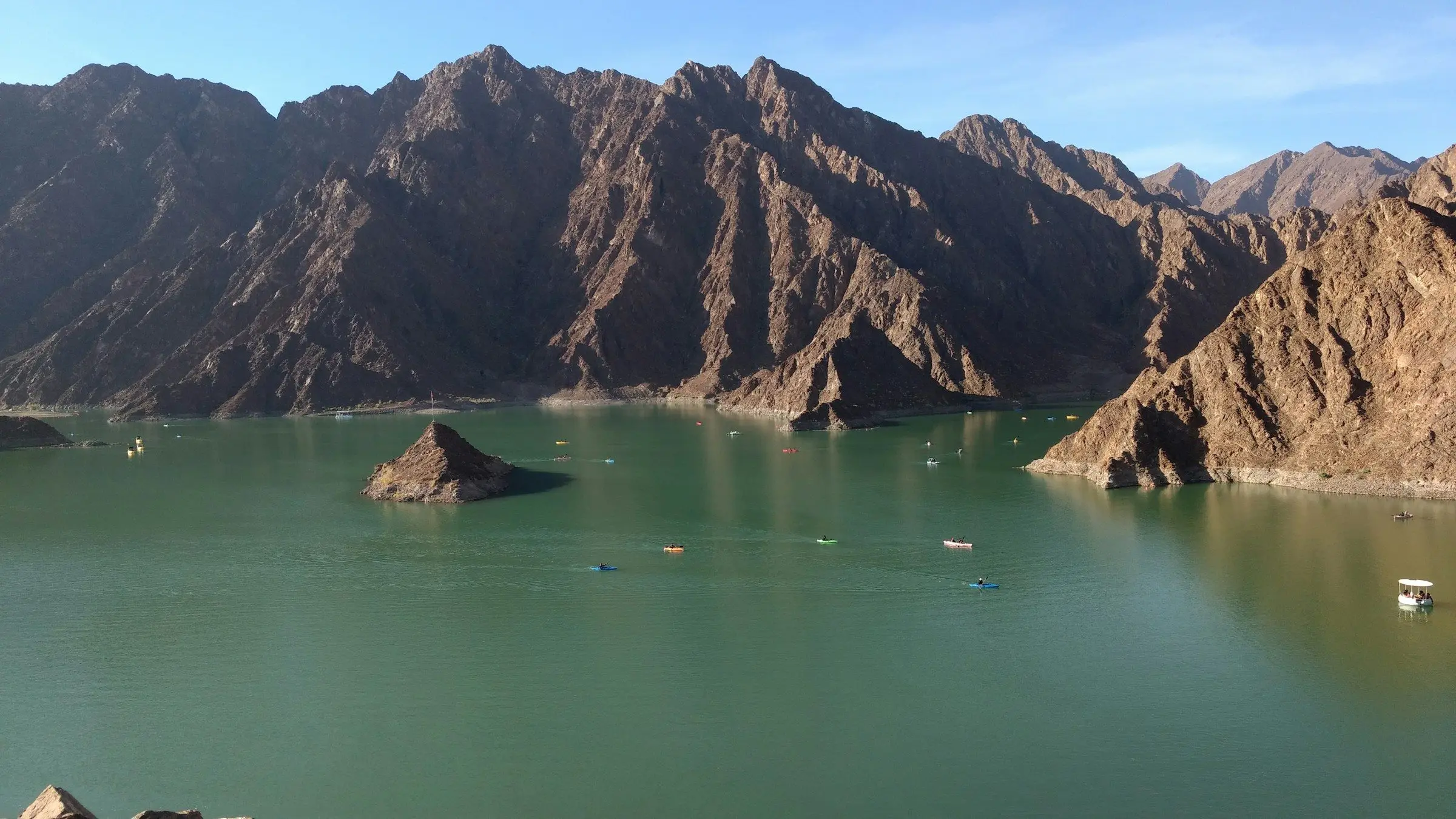 Hatta Dam's green lake among the Hajar Mountains