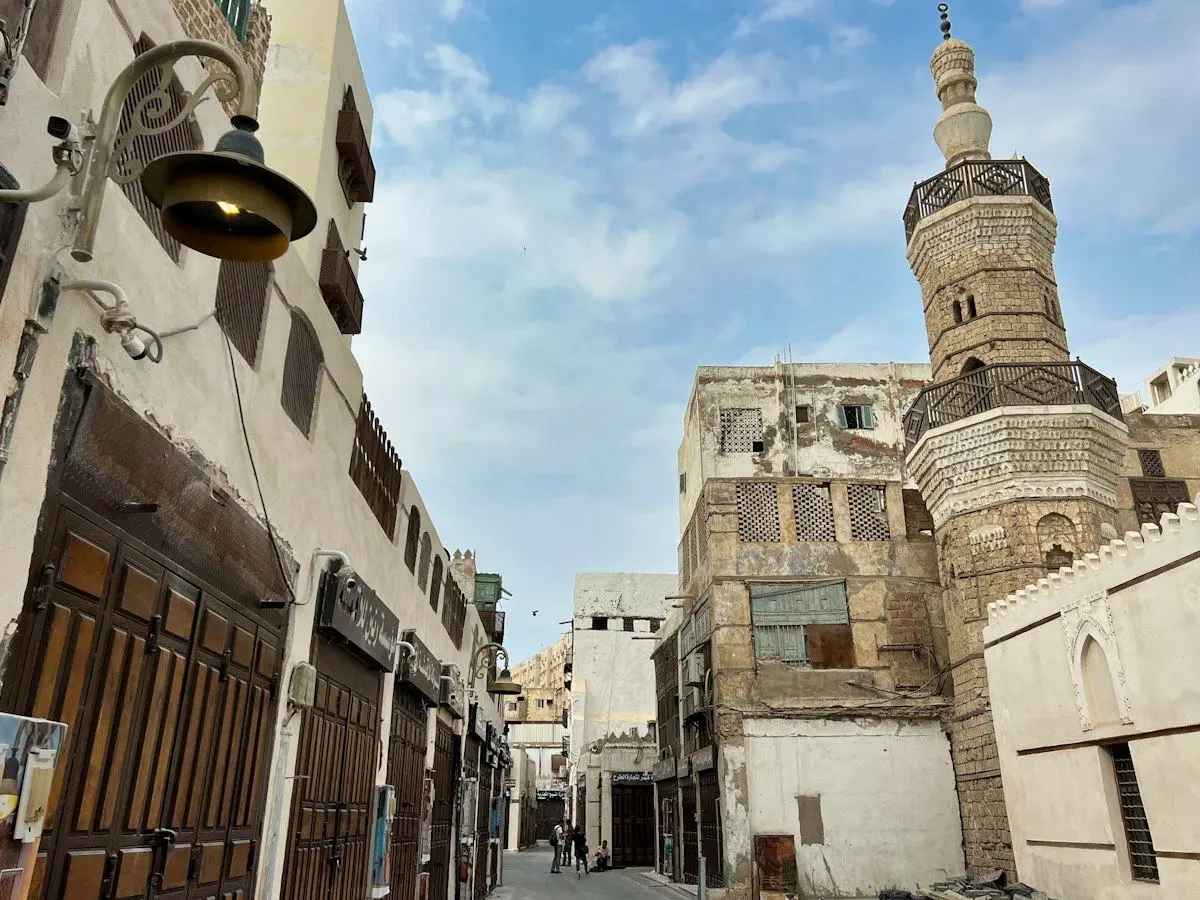 A lane of coral-stone houses and a minaret in Al-Balad, historic Jeddah