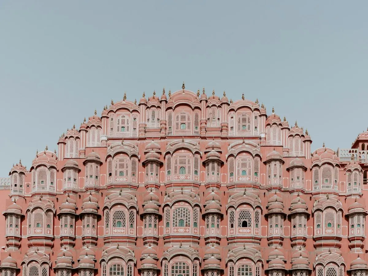 The pink sandstone facade of the Hawa Mahal in Jaipur
