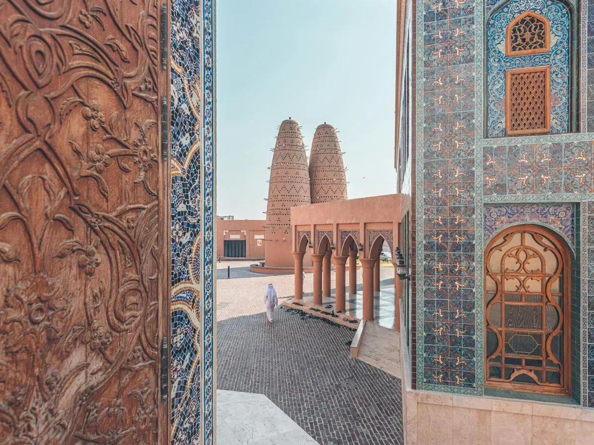 The pigeon towers of Katara Cultural Village framed by a carved doorway