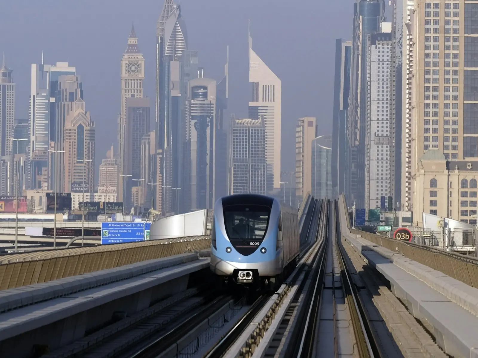 قطار مترو دبي على الخط العلوي، وأبراج خلفه