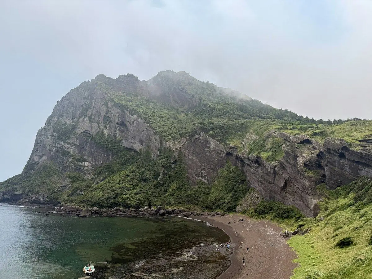 A volcanic headland and dark shore on Jeju Island
