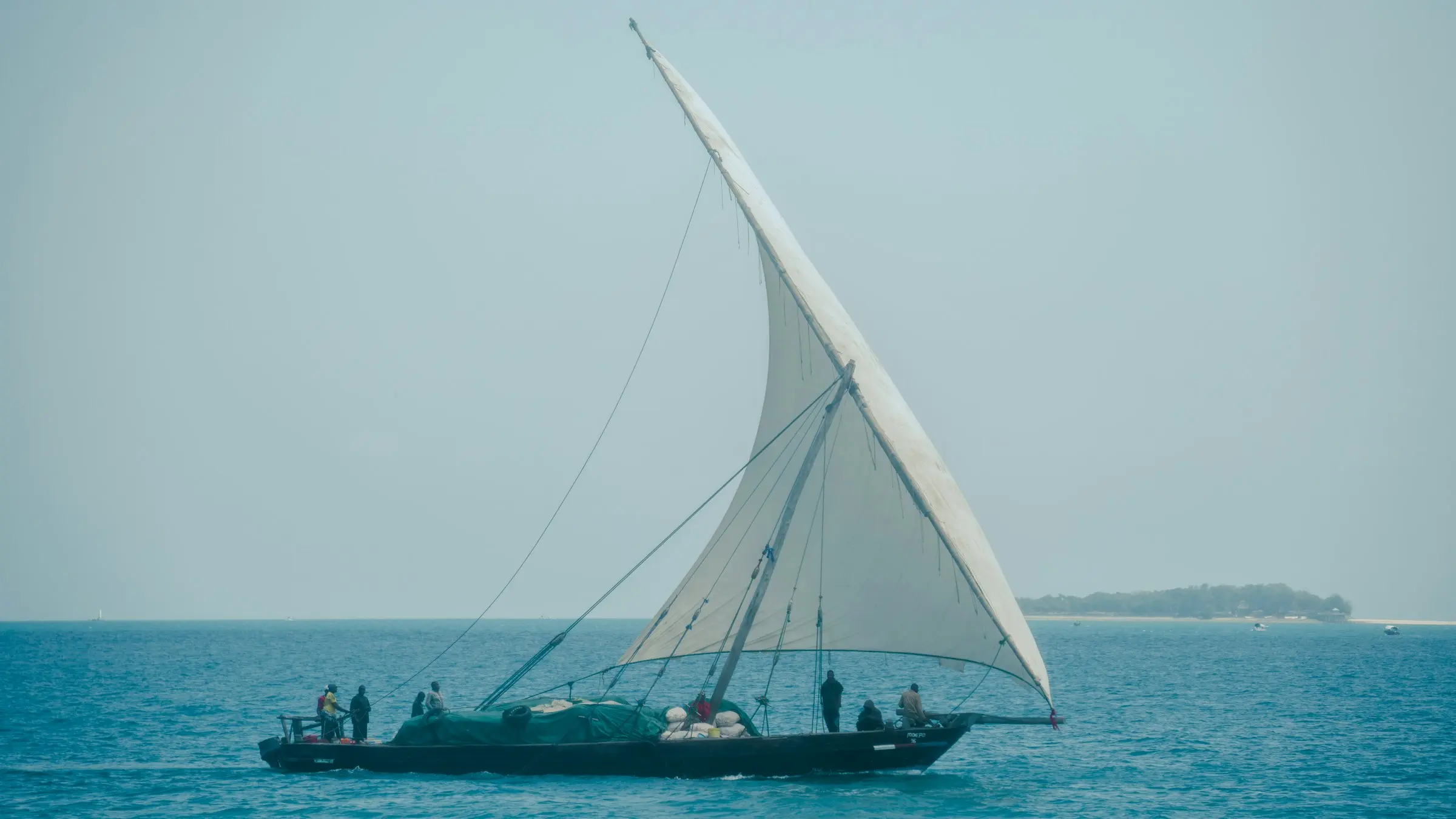 A dhow under sail on the turquoise sea off Zanzibar