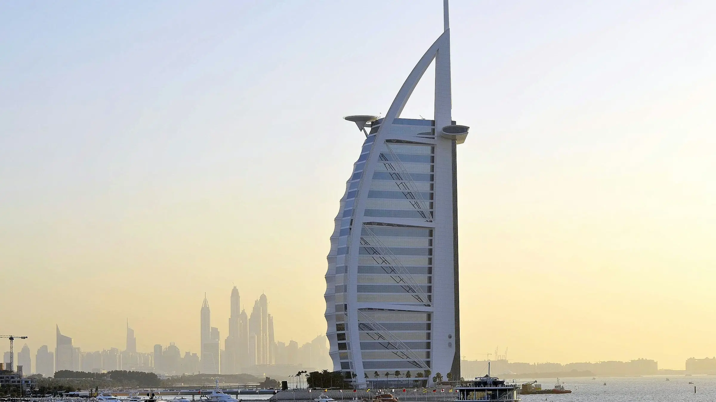 The Burj Al Arab at sunset, with Dubai Marina on the horizon