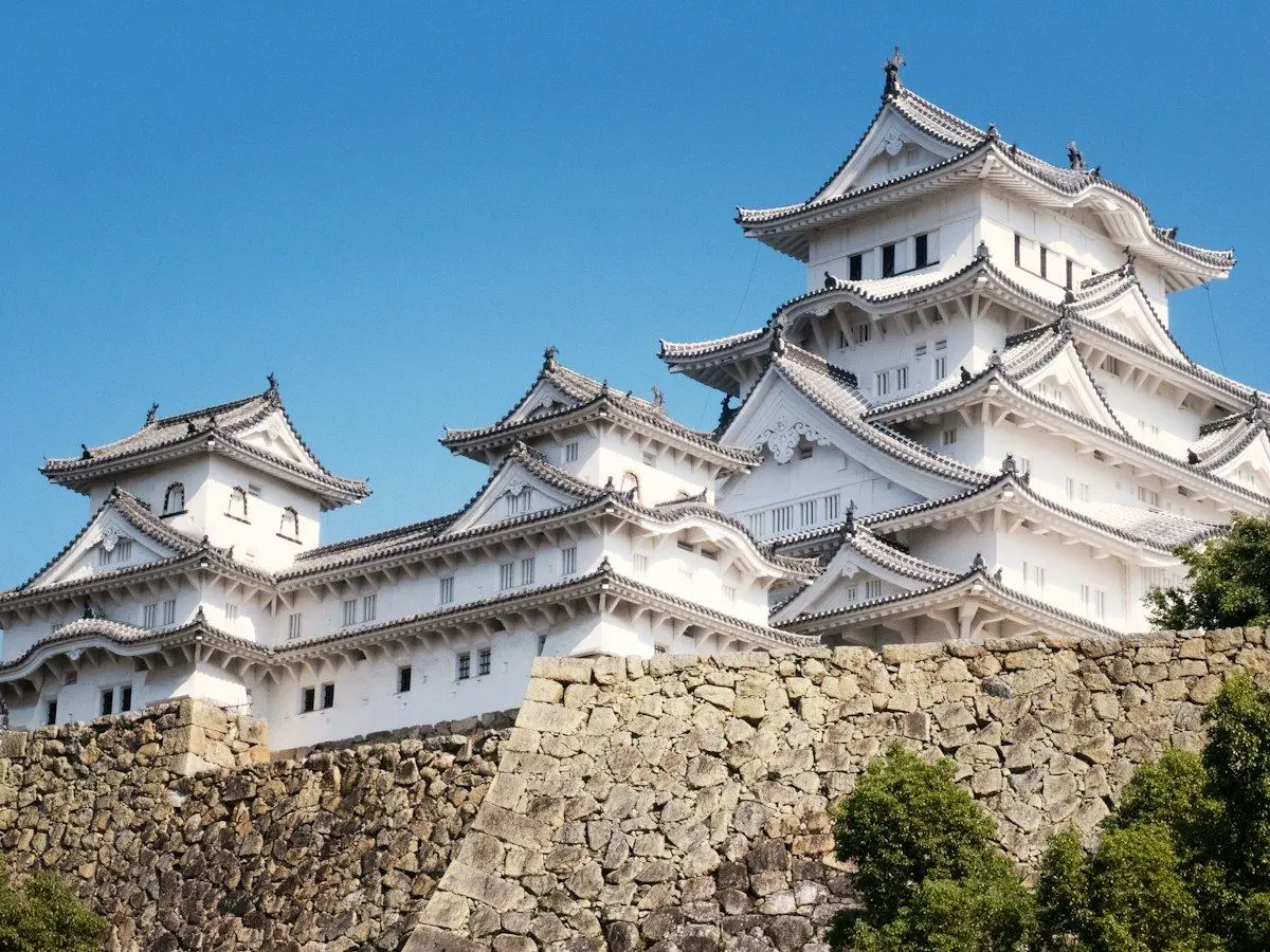 The white keep of Himeji Castle above its stone walls