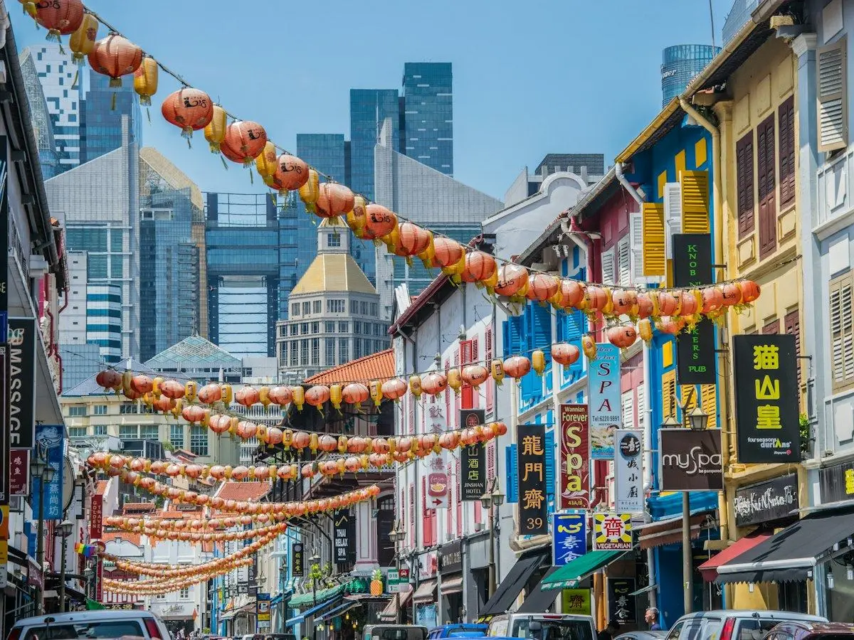 Lanterns strung over a street of shophouses in Chinatown, Singapore